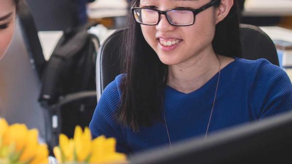 women looking at laptop and smiling