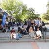 Students sitting on steps at an event.
