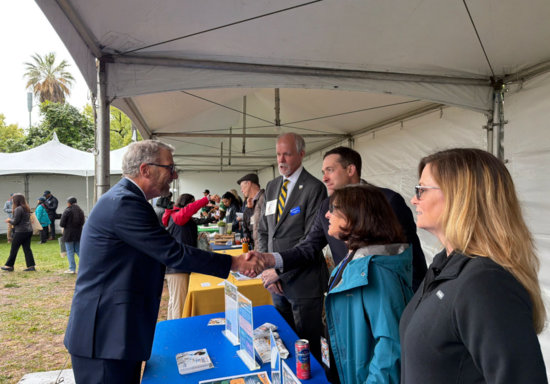 James B. Milliken, president of the University of California, greets Houston Wilson, Associate Professor in the Department of Entomology, during California Agricultural Day at the Capitol in Sacramento. Also pictured are CNAS Dean Peter Atkinson, Patricia Springer, and CNAS student Angel Zarobinski.